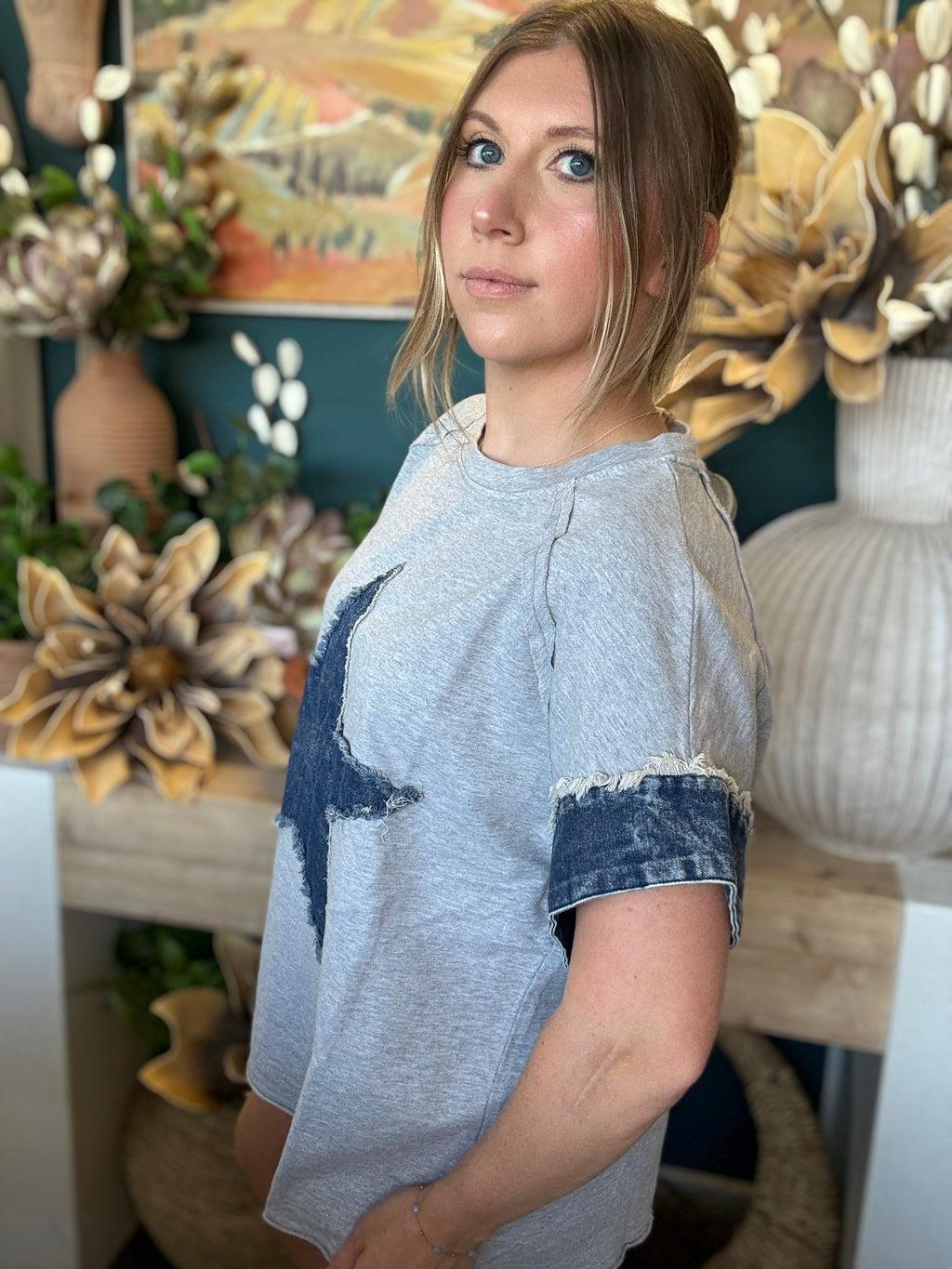 women's oversized gray top with distressed denim star applique and rolled denim sleeves