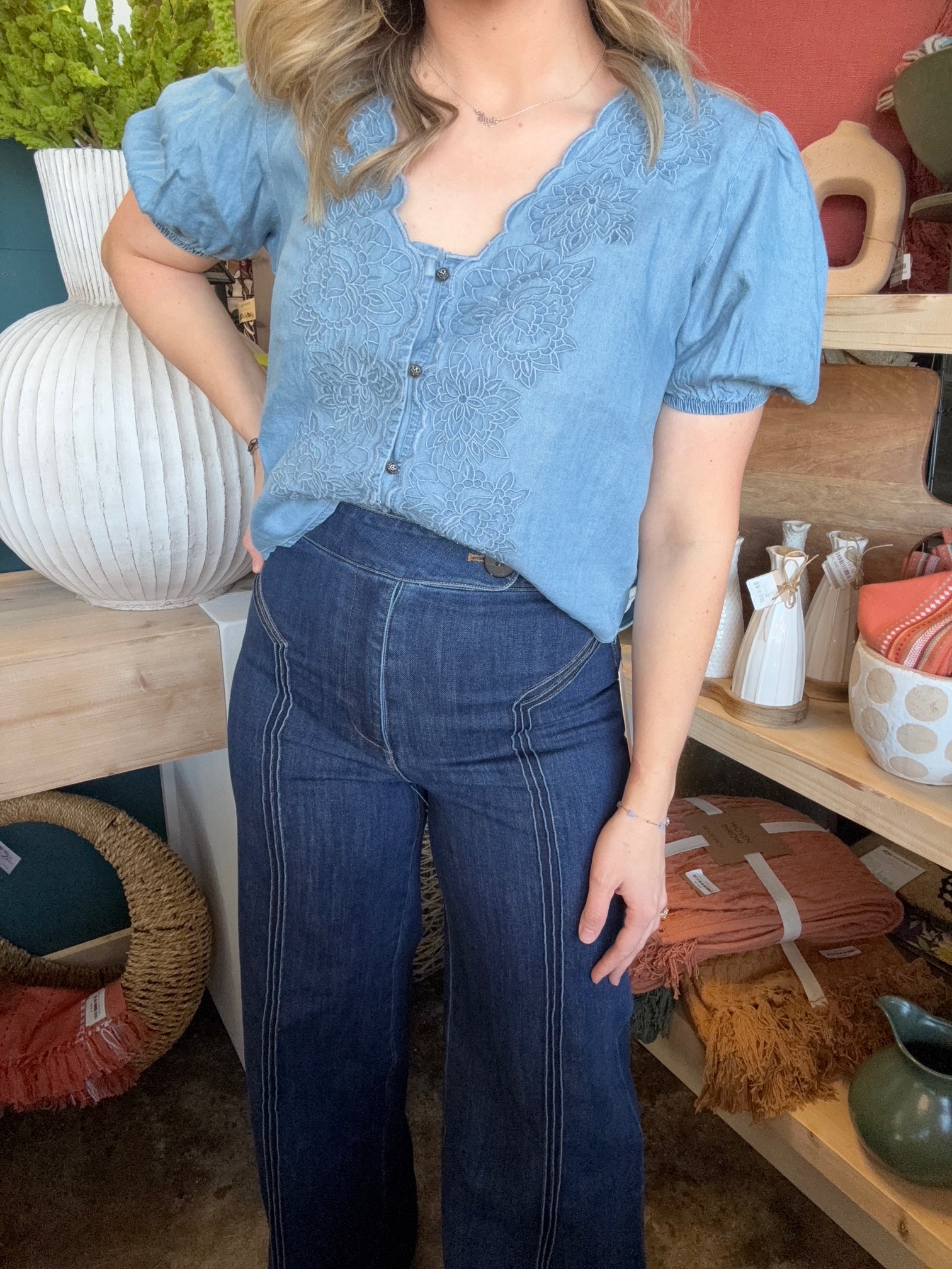 woman wearing embroidered chambray boutique top with puff sleeves and button front