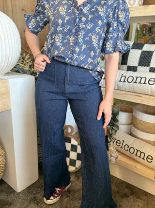 indigo pull-on pants with front patch pockets and ruffle hem detail
