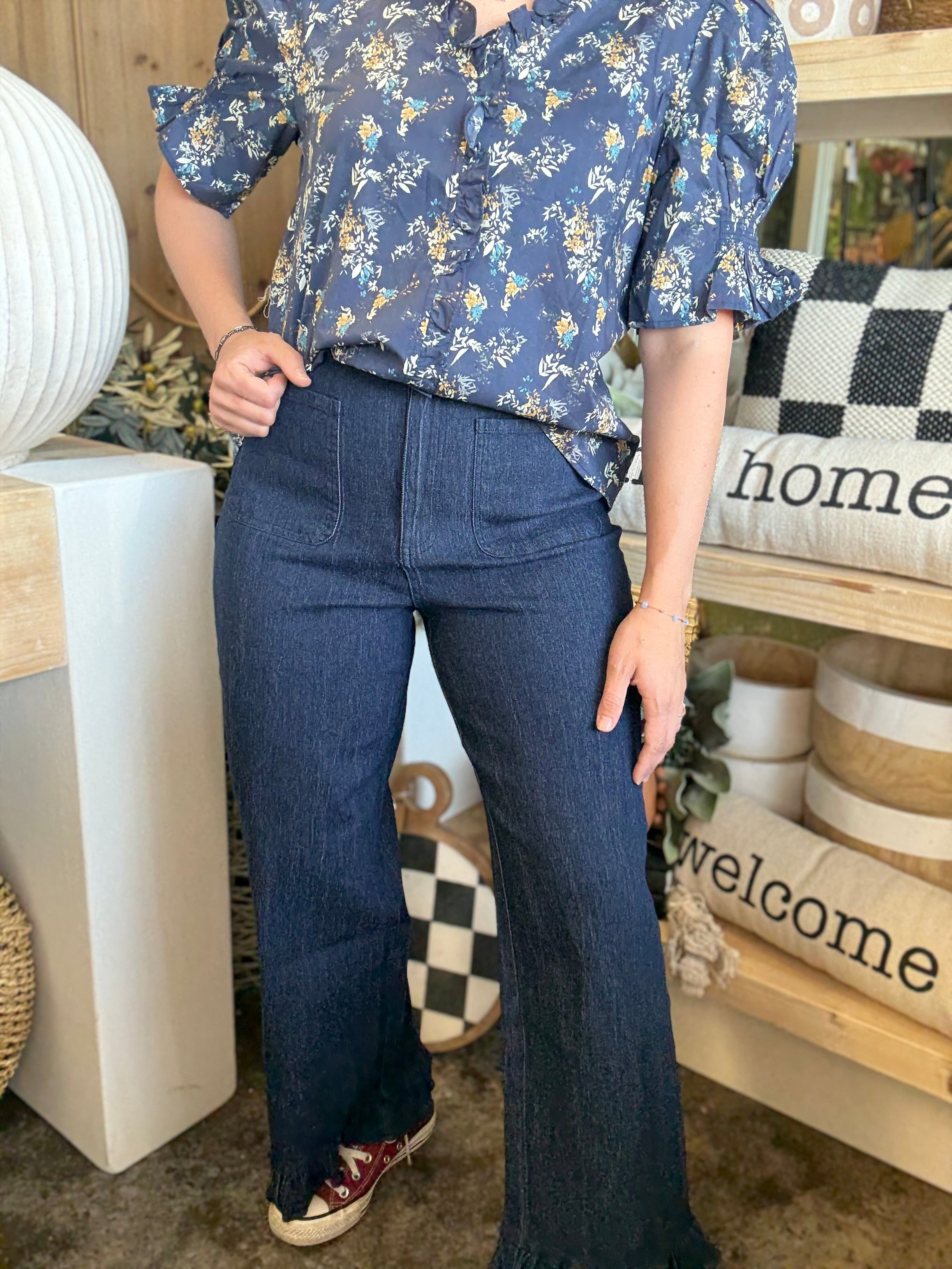 indigo pull-on pants with front patch pockets and ruffle hem detail