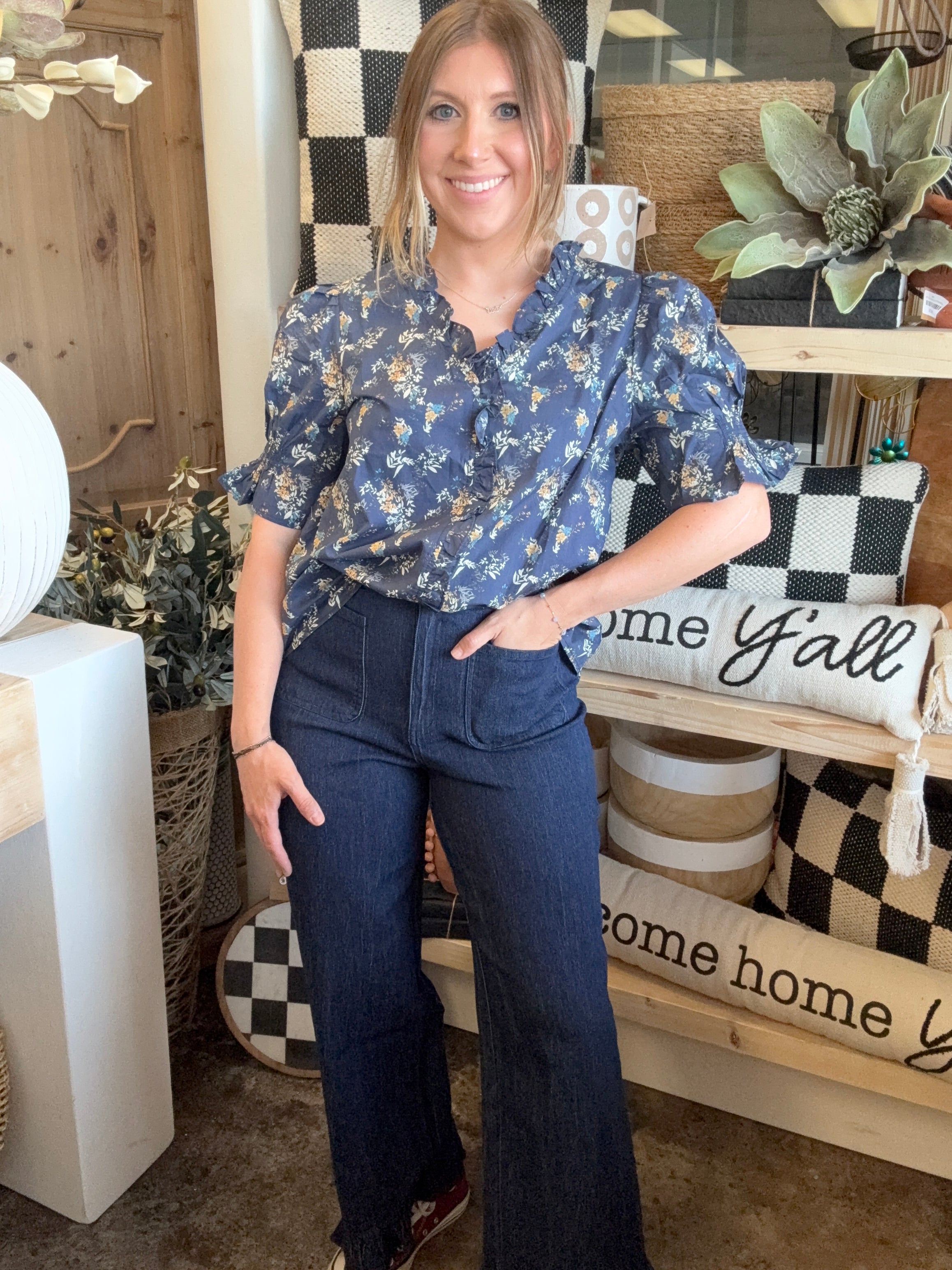 navy floral blouse with ruffled neckline and short flutter sleeves