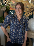 navy floral blouse with ruffled neckline and short flutter sleeves
