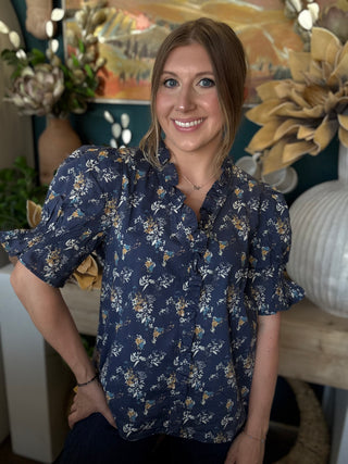 navy floral blouse with ruffled neckline and short flutter sleeves