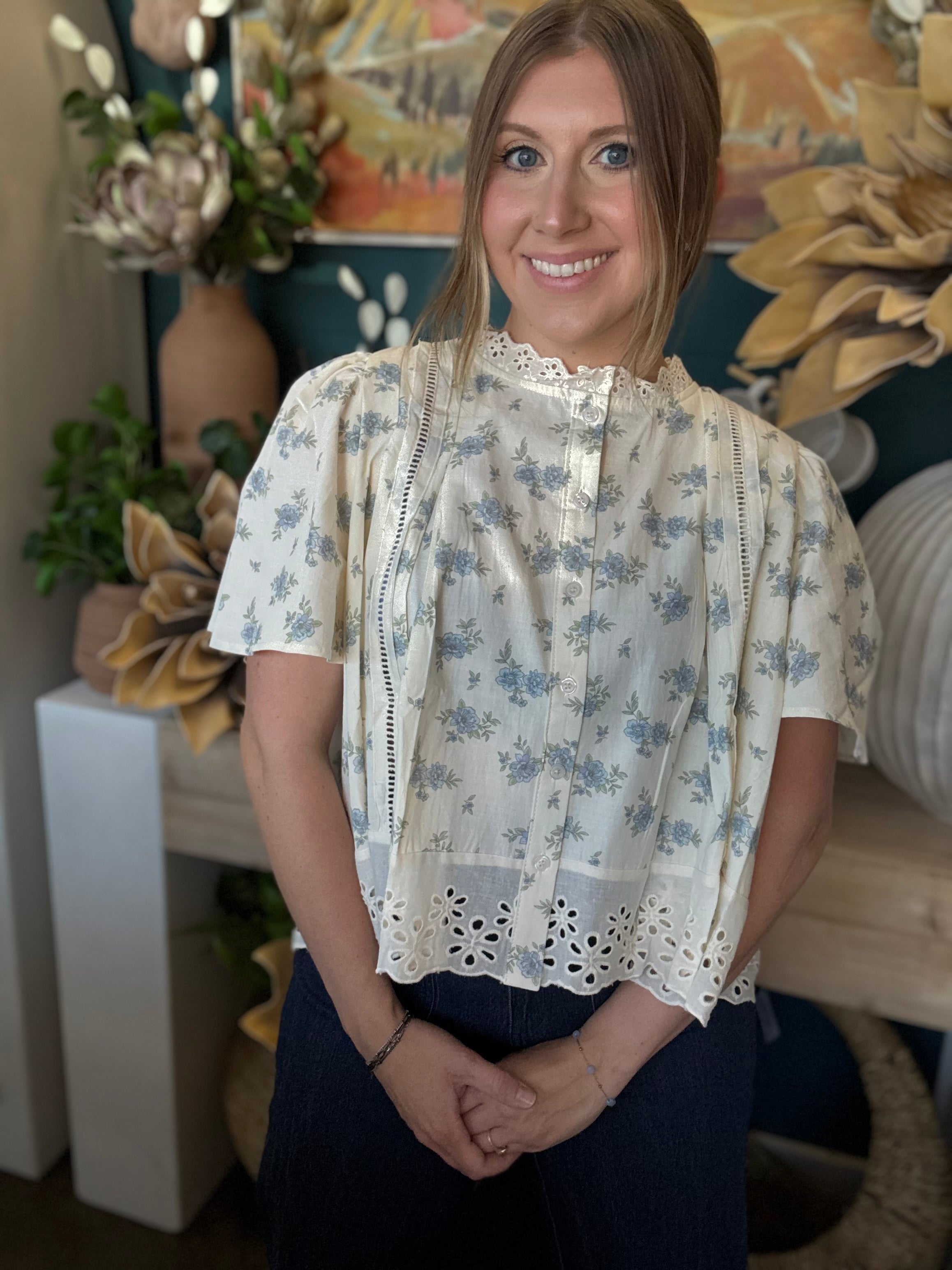 ivory floral blouse with blue flowers lace trim flutter sleeves and eyelet hem detail