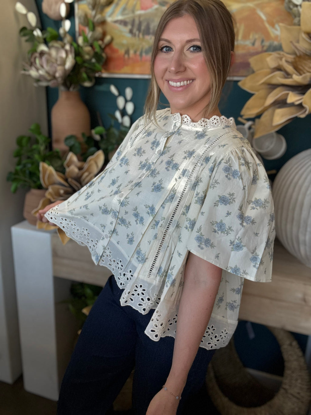 ivory floral blouse with blue flowers lace trim flutter sleeves and eyelet hem detail