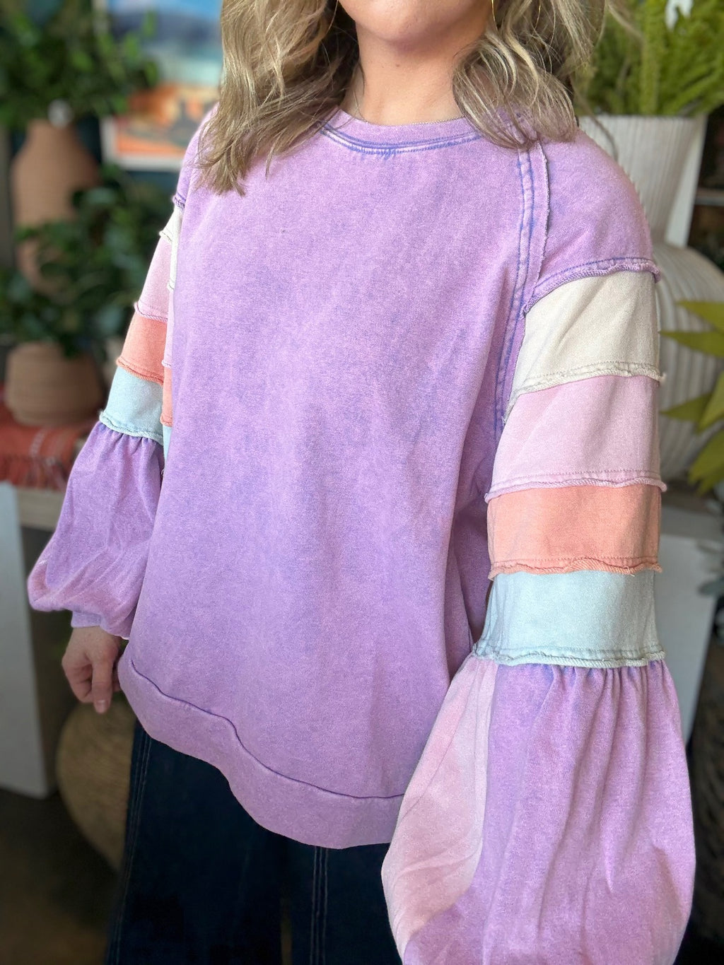 woman wearing lavender boutique pullover with pastel tiered sleeves