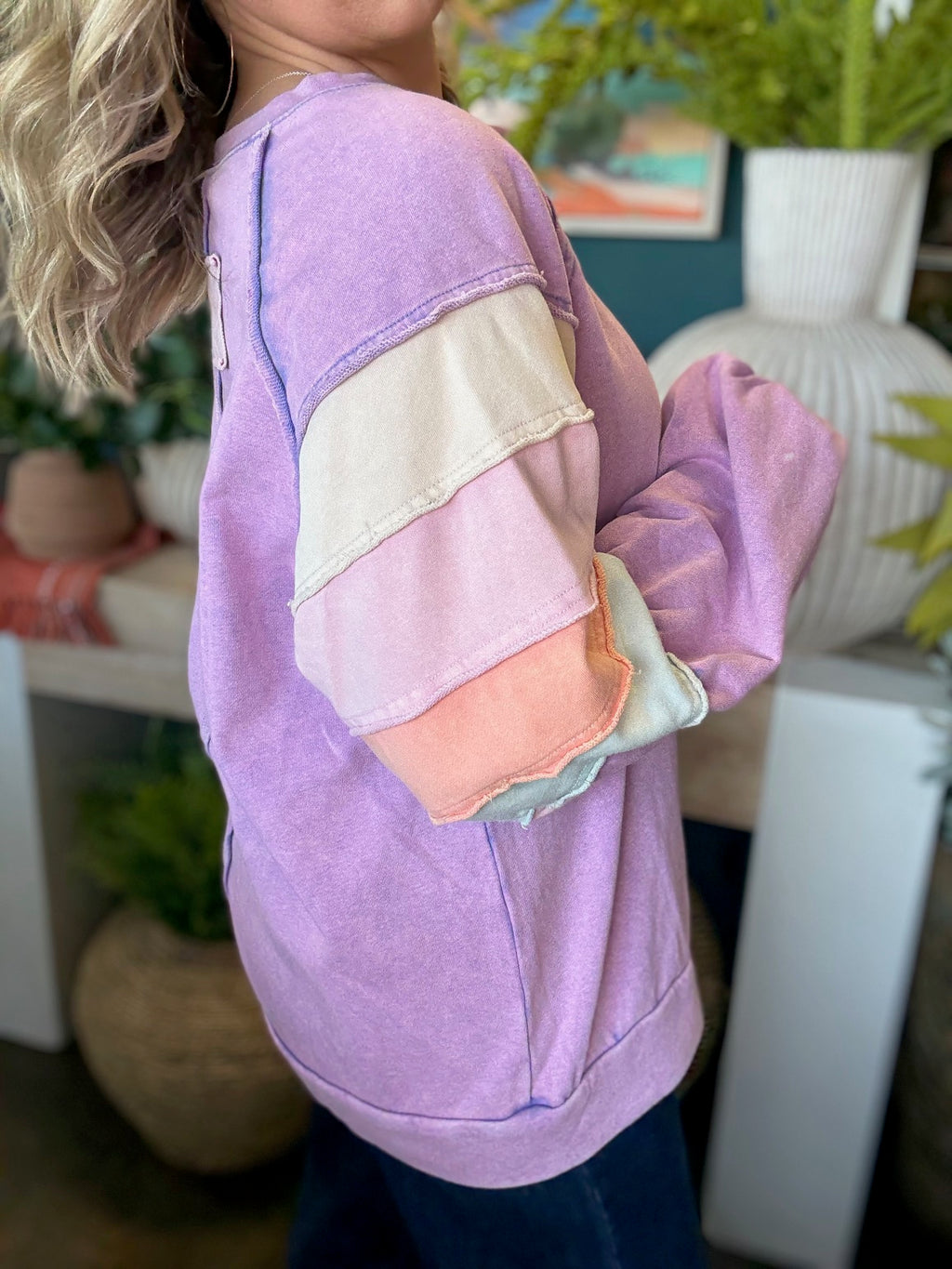 woman wearing lavender boutique pullover with pastel tiered sleeves