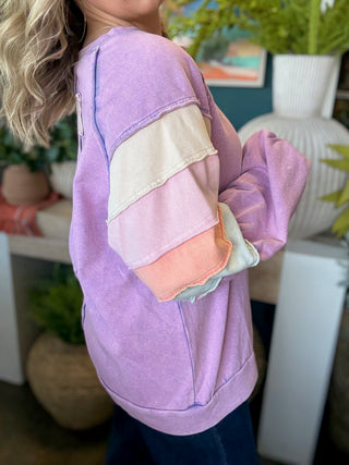 woman wearing lavender boutique pullover with pastel tiered sleeves