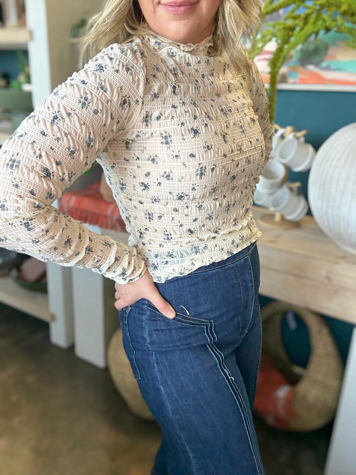 woman wearing floral smocked mock neck boutique top with long sleeves