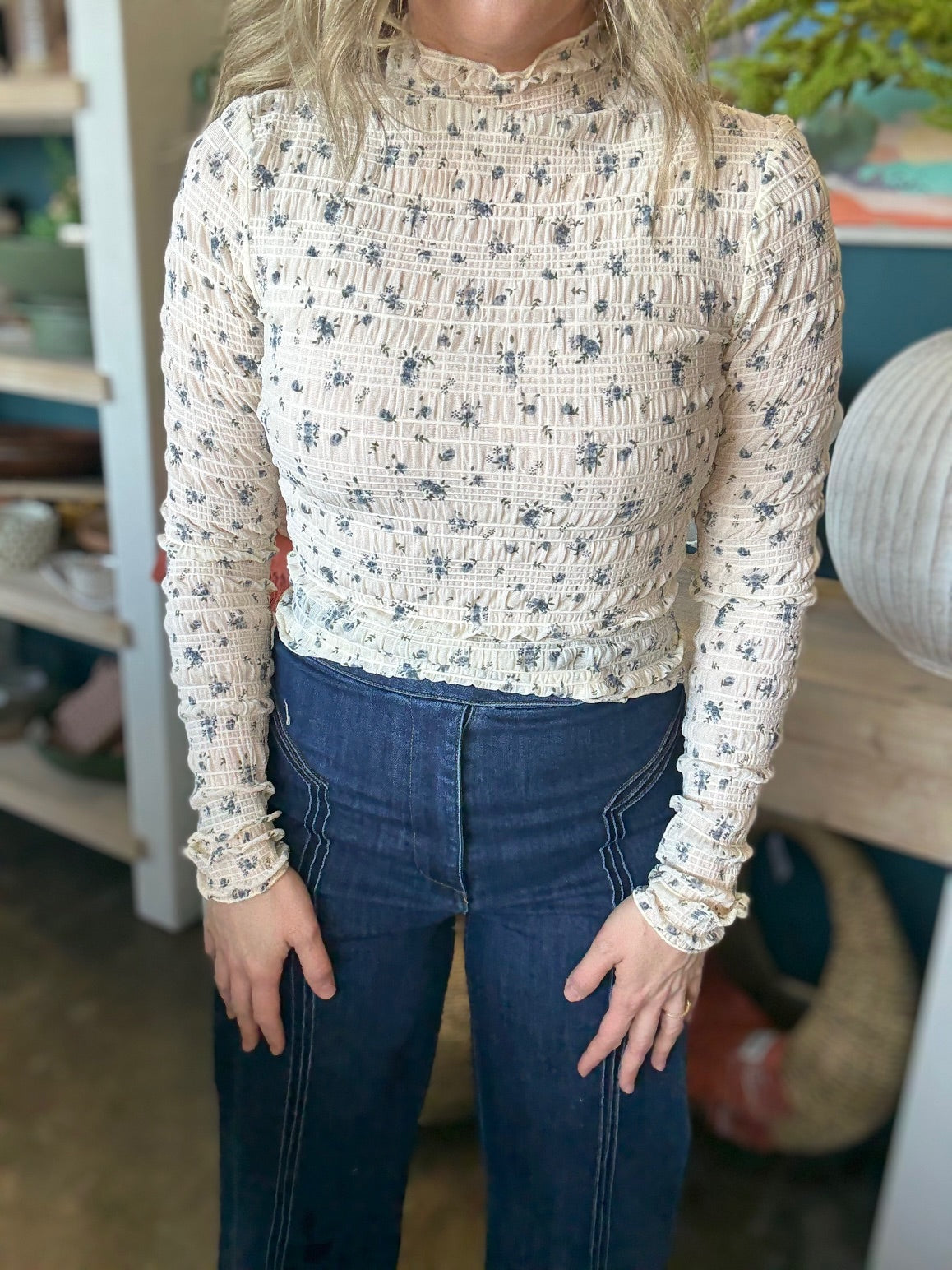 woman wearing floral smocked mock neck boutique top with long sleeves