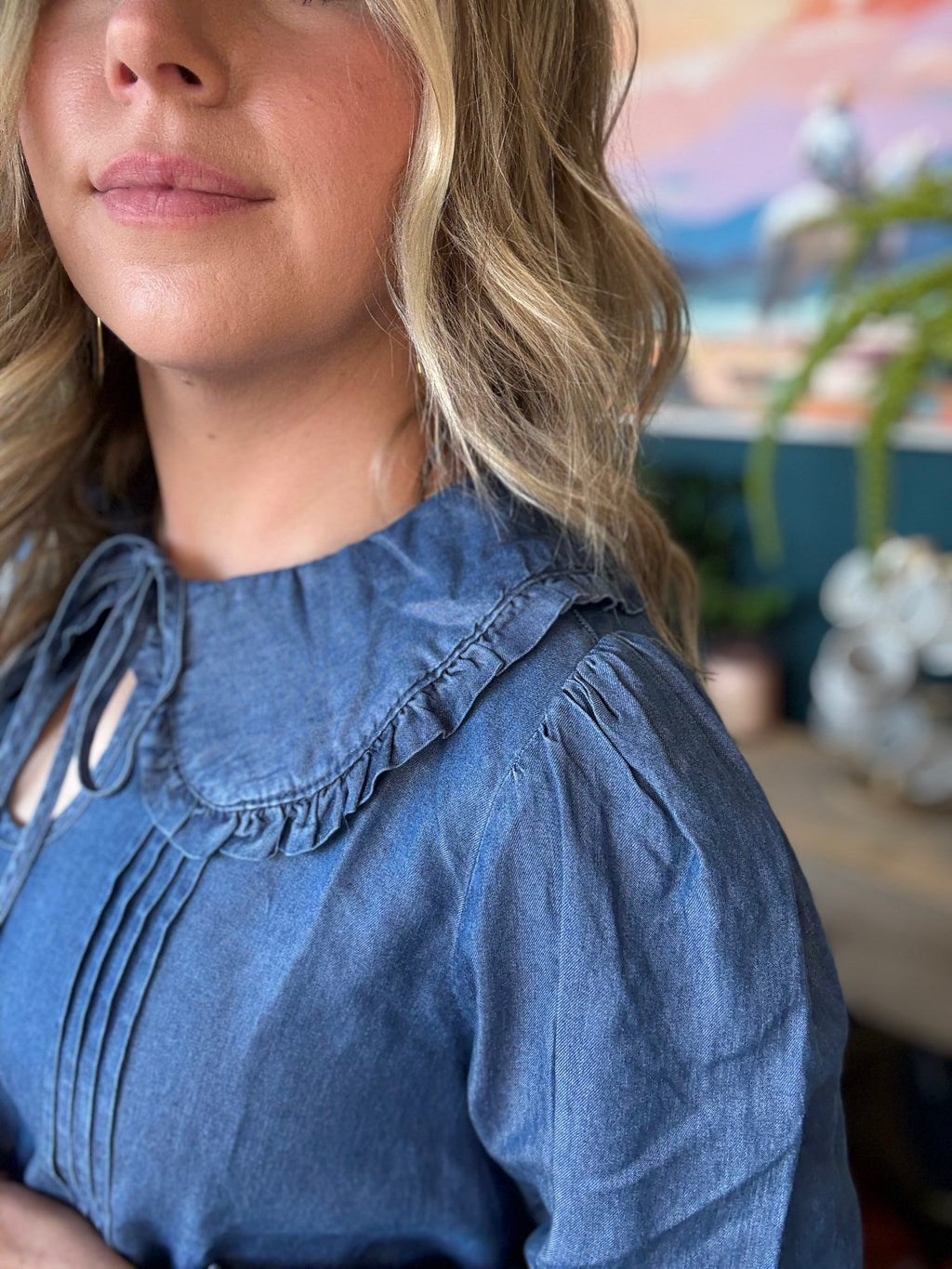 woman wearing chambray boutique blouse with tie neckline and pintuck detailing