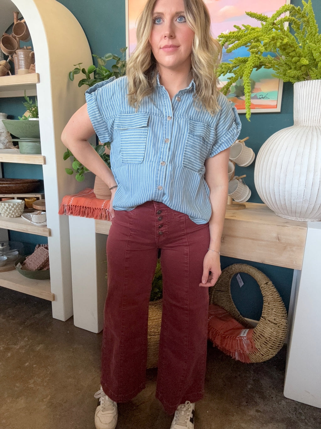 woman wearing rust high waisted button front wide leg boutique pants