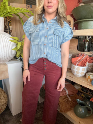 woman wearing rust high waisted button front wide leg boutique pants
