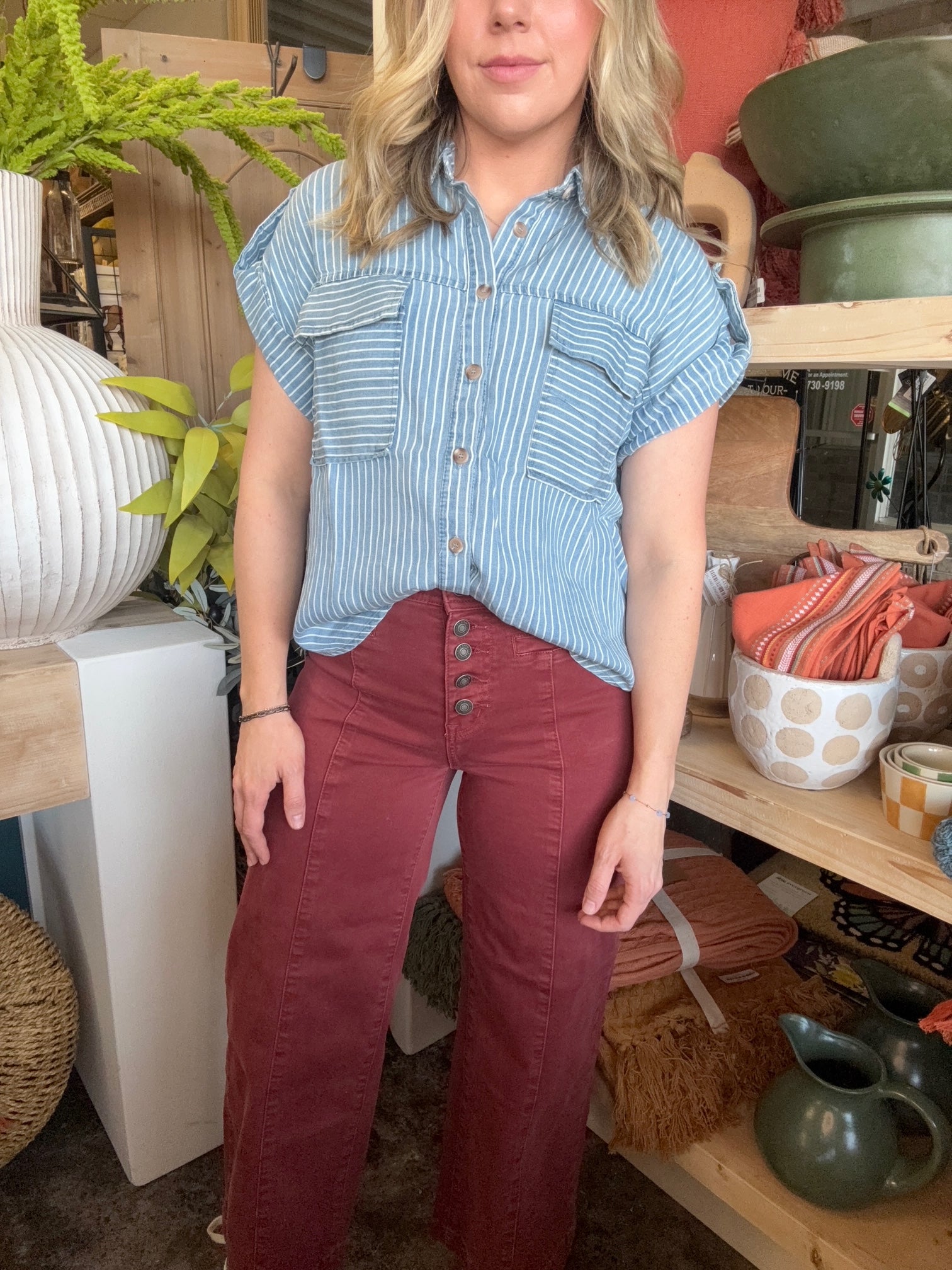 woman wearing rust high waisted button front wide leg boutique pants