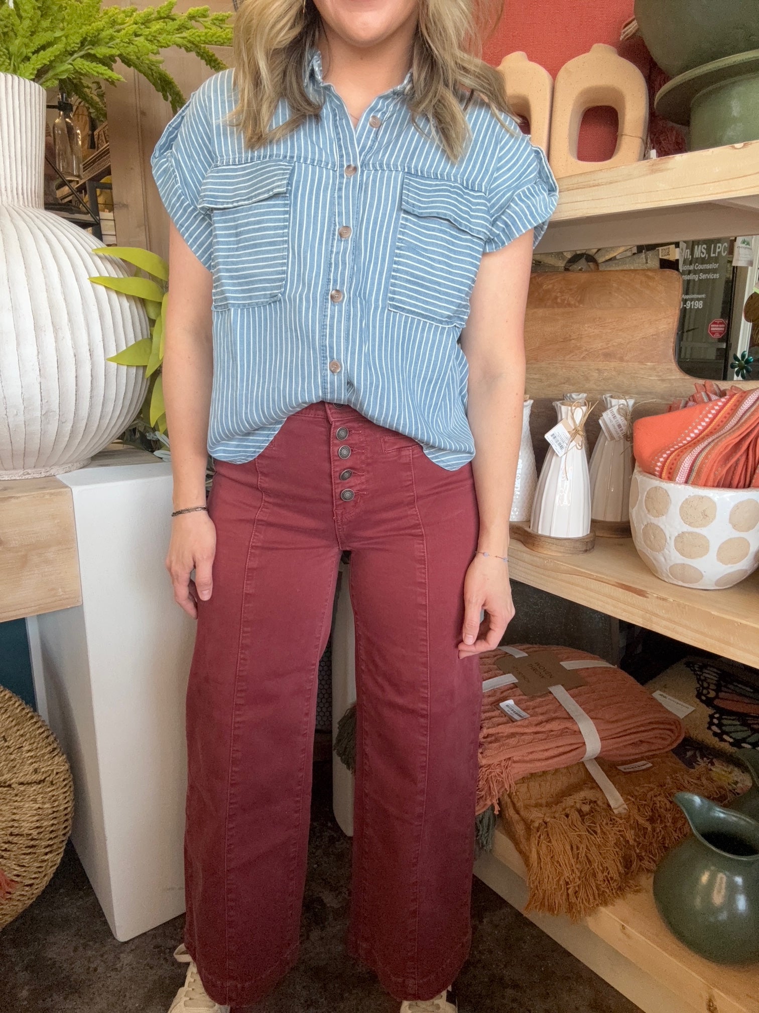 woman wearing rust high waisted button front wide leg boutique pants