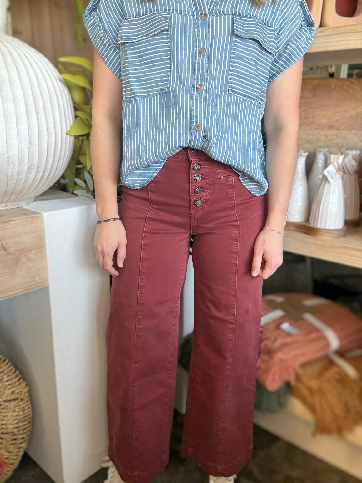 woman wearing rust high waisted button front wide leg boutique pants