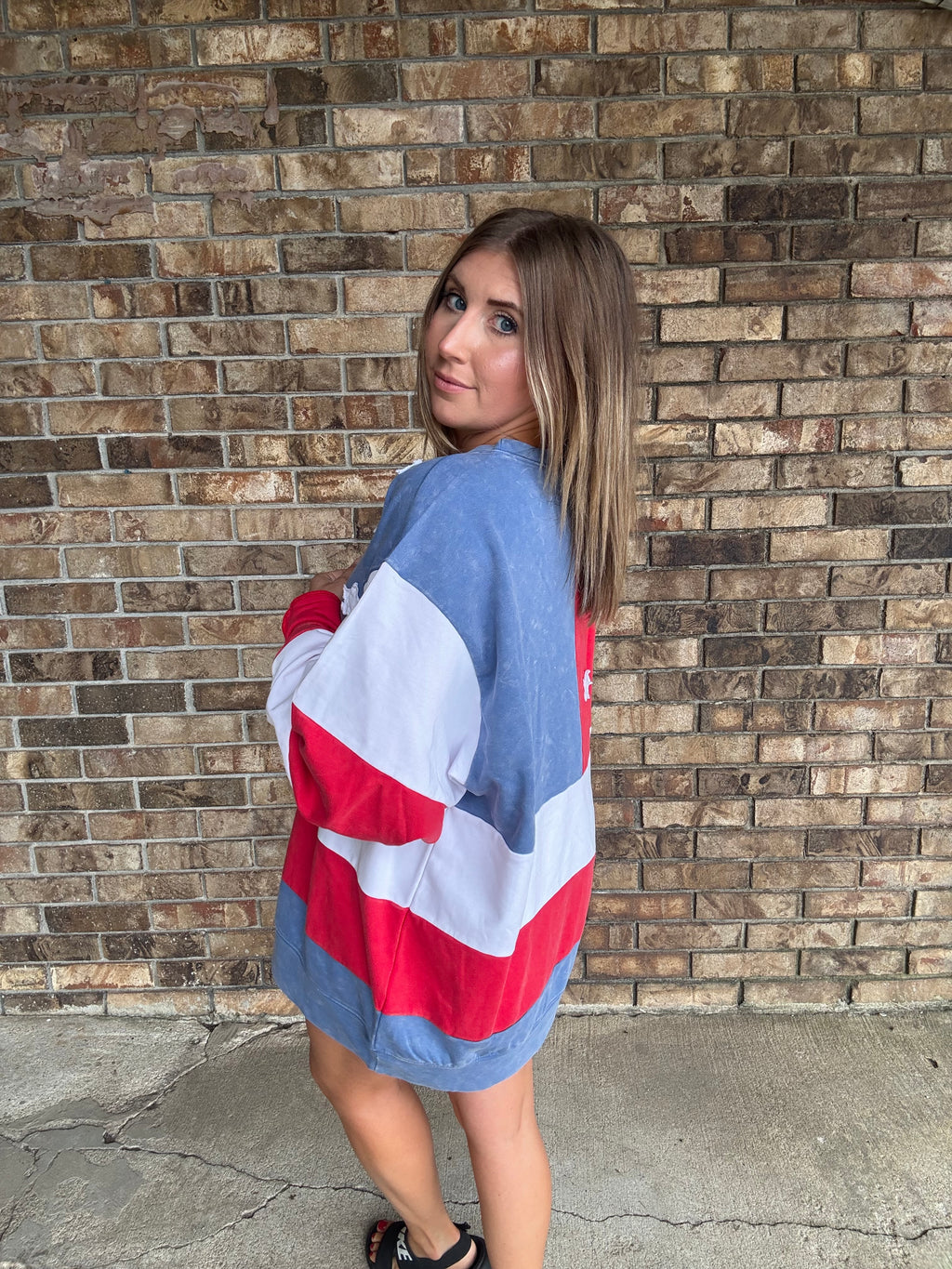 Woman wearing a mineral washed oversized Americana flag sweatshirt with vintage stars and stripes design