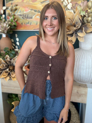 Woman wearing chambray blue ruffle hem shorts with an elastic drawstring waistband and side pockets