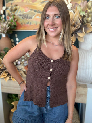 Woman wearing a mocha brown knit sweater tank top with front button details and adjustable spaghetti straps