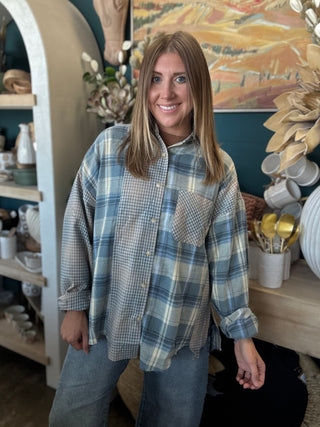 Woman wearing an oversized blue mixed plaid patchwork button-down shirt with long sleeves