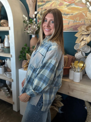 Woman wearing an oversized blue mixed plaid patchwork button-down shirt with long sleeves
