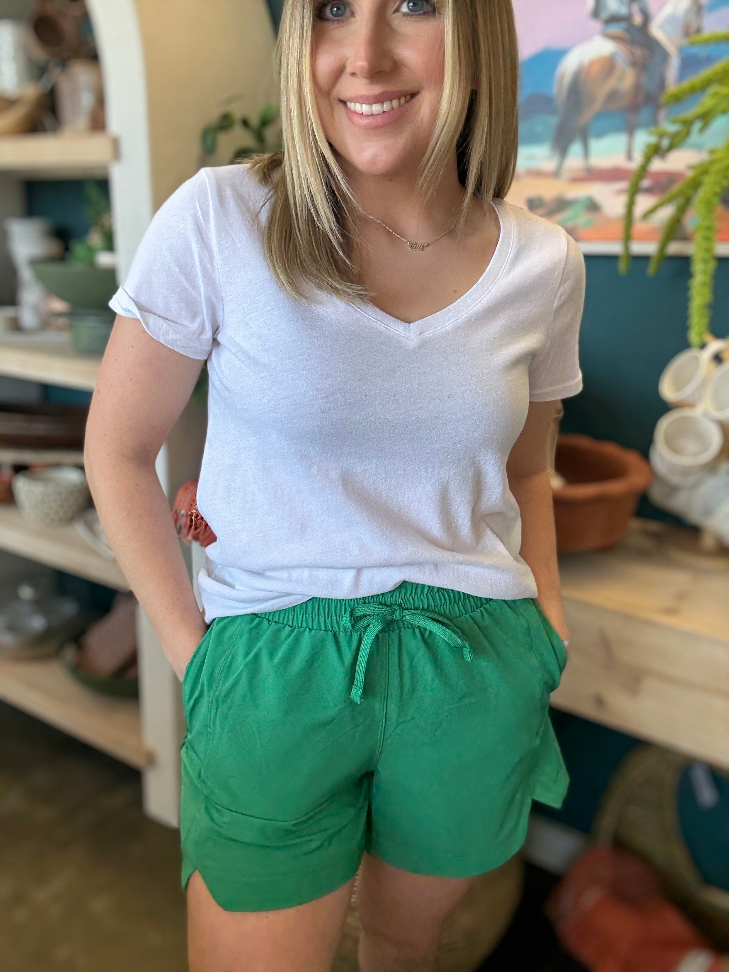 woman wearing emerald green eyelet boutique drawstring shorts