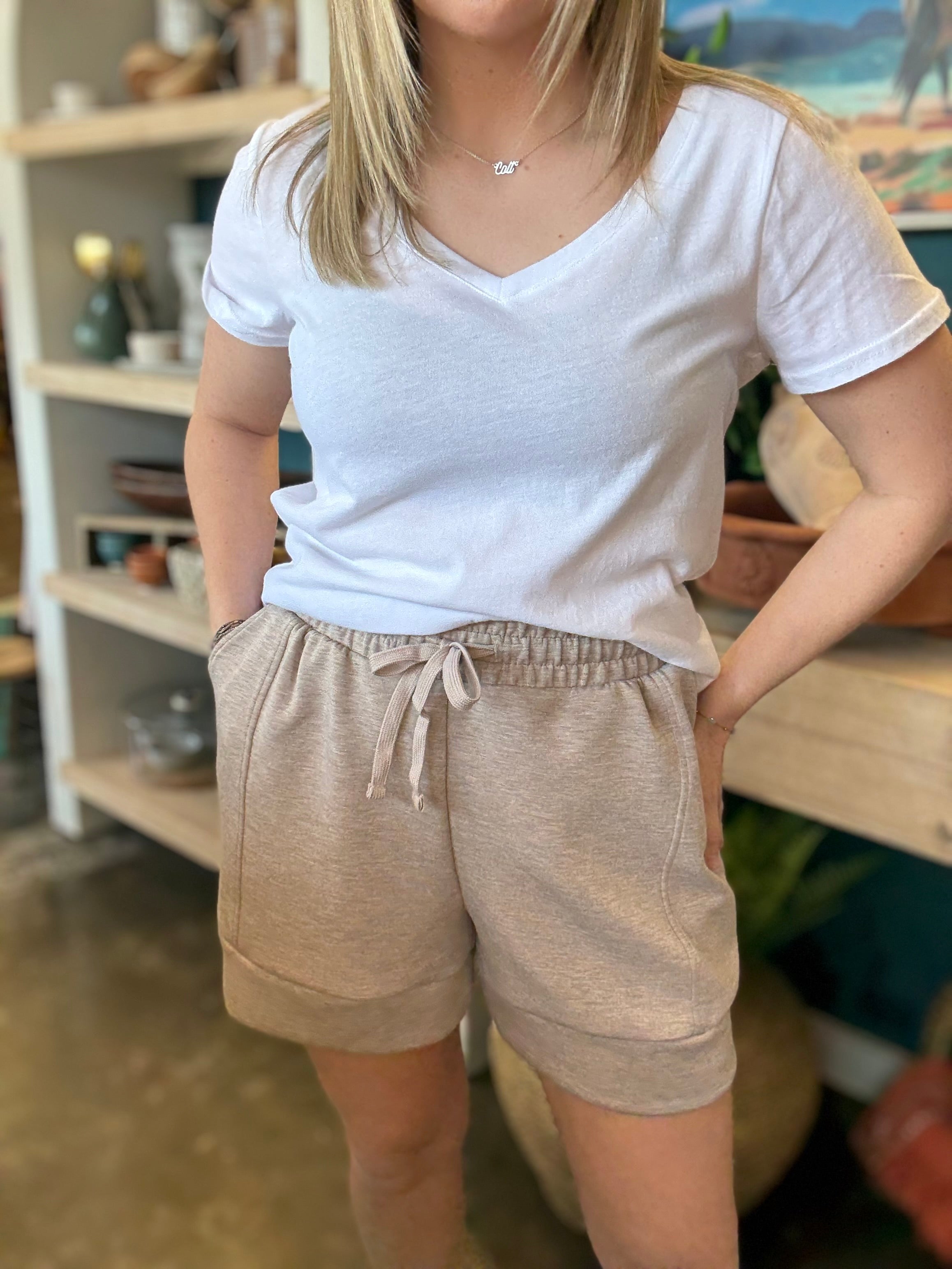 woman wearing neutral drawstring boutique lounge shorts with pockets