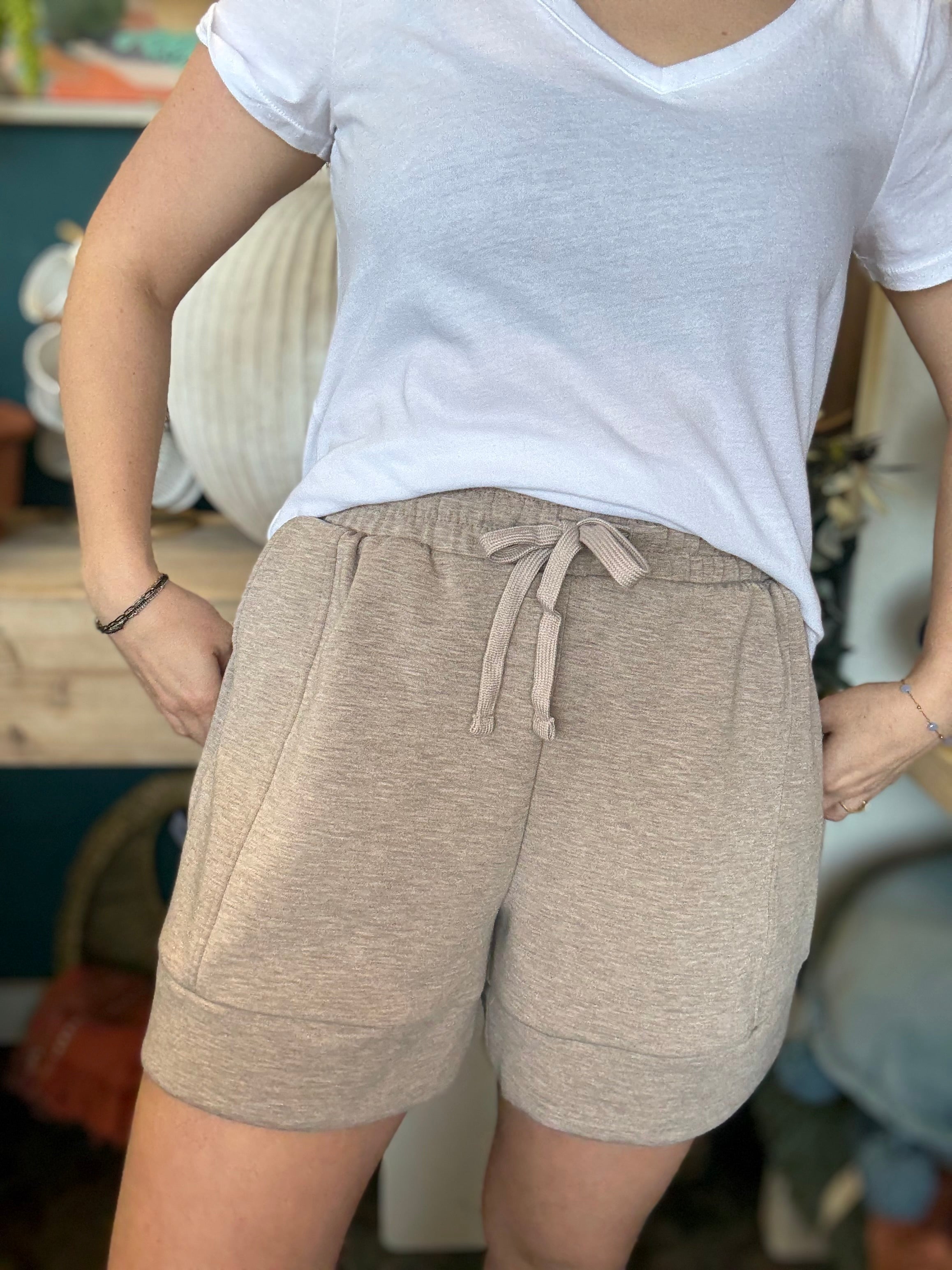 woman wearing neutral drawstring boutique lounge shorts with pockets