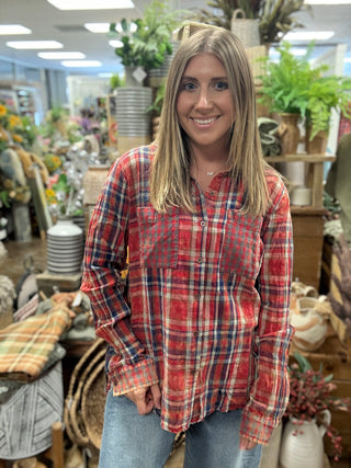 Woman wearing a vintage washed red plaid button-down shirt with chest pockets and a raw fringe hem