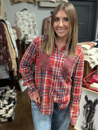 Woman wearing a vintage washed red plaid button-down shirt with chest pockets and a raw fringe hem