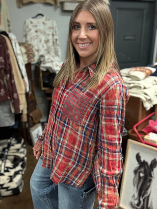 Woman wearing a vintage washed red plaid button-down shirt with chest pockets and a raw fringe hem