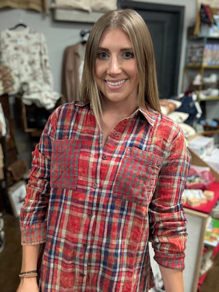 Woman wearing a vintage washed red plaid button-down shirt with chest pockets and a raw fringe hem