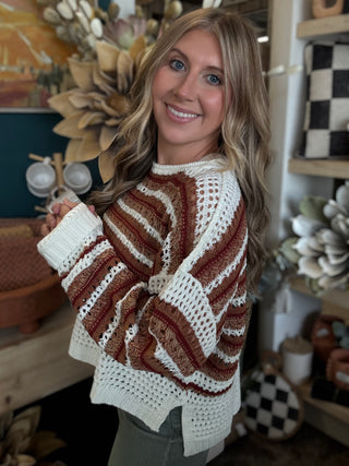 Woman wearing the Sunset Drive relaxed fit open-knit sweater in rust, camel and ivory.