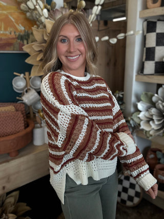 Woman wearing the Sunset Drive relaxed fit open-knit sweater in rust, camel and ivory.