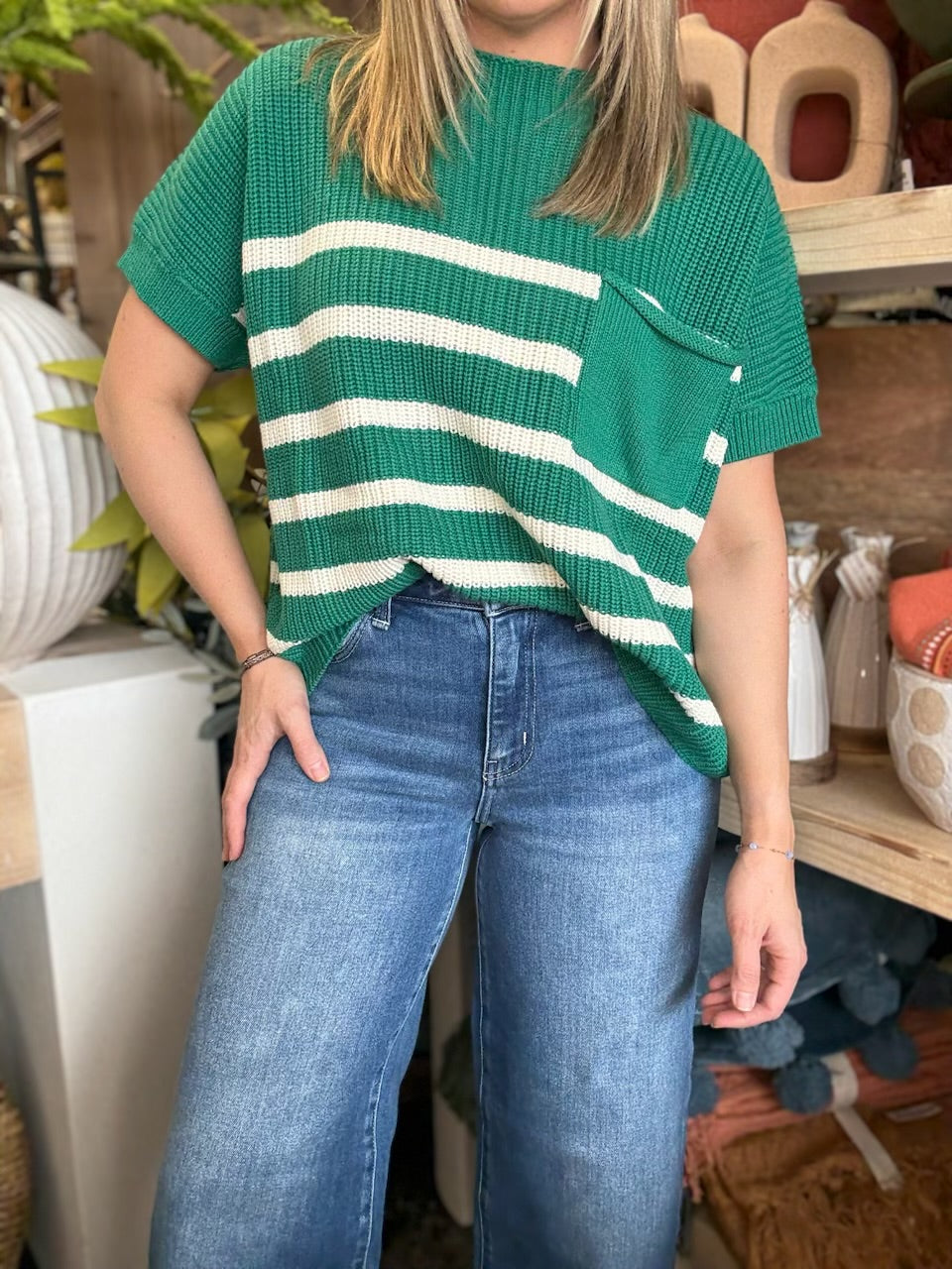 woman wearing emerald green striped boutique sweater top with pocket