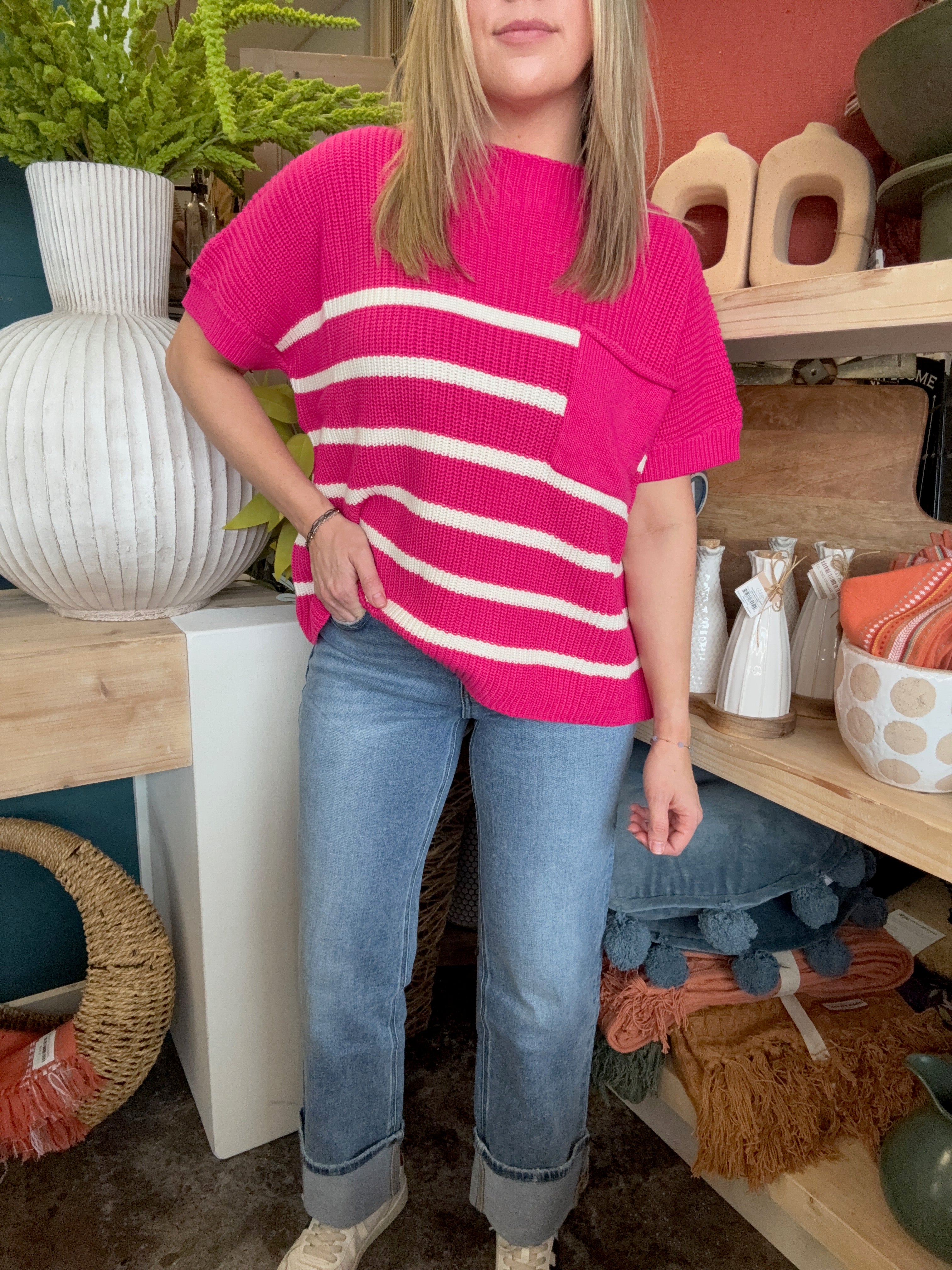 woman wearing bright pink striped boutique sweater top with pocket