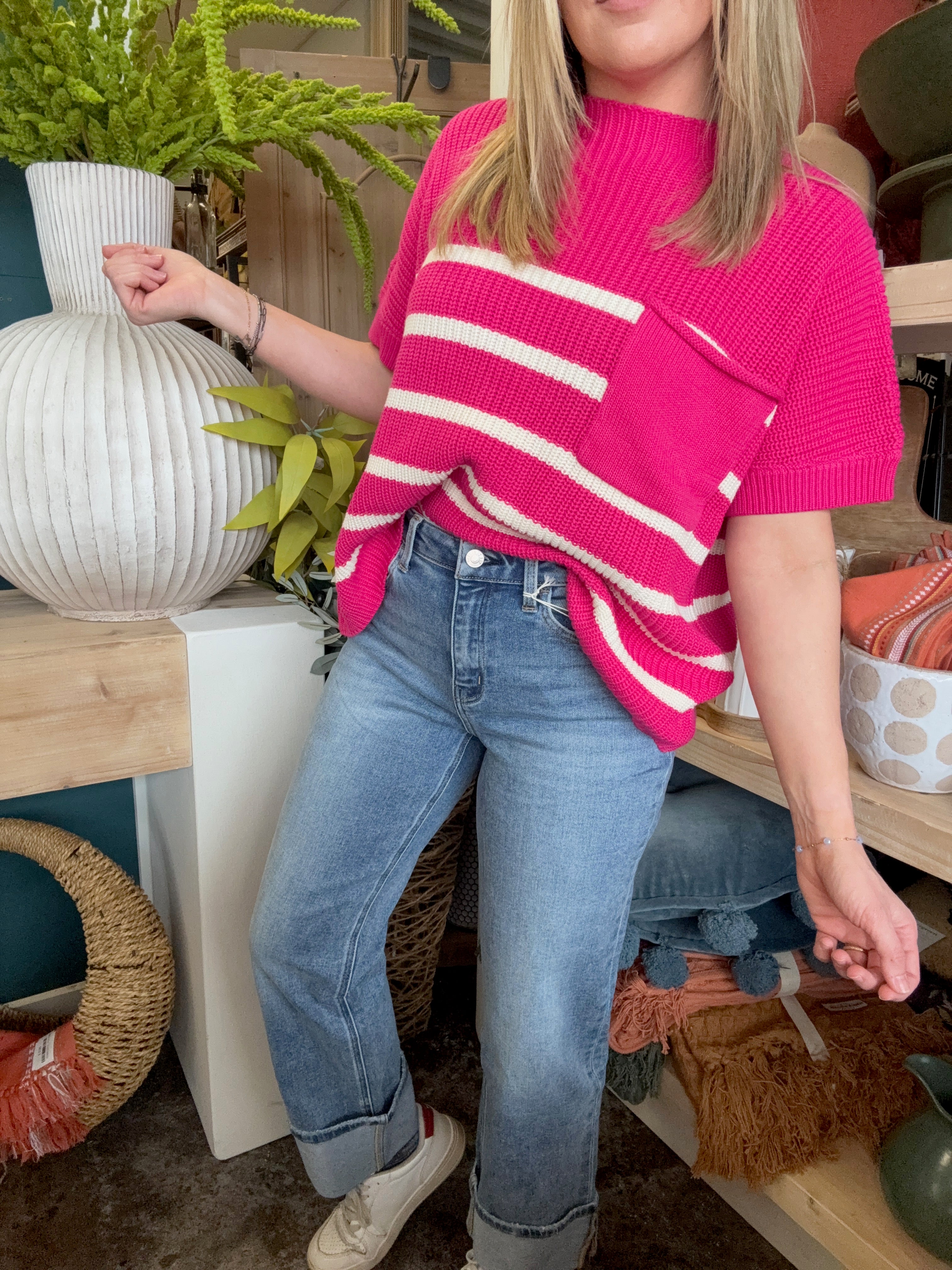 woman wearing mid rise straight leg cuffed boutique jeans