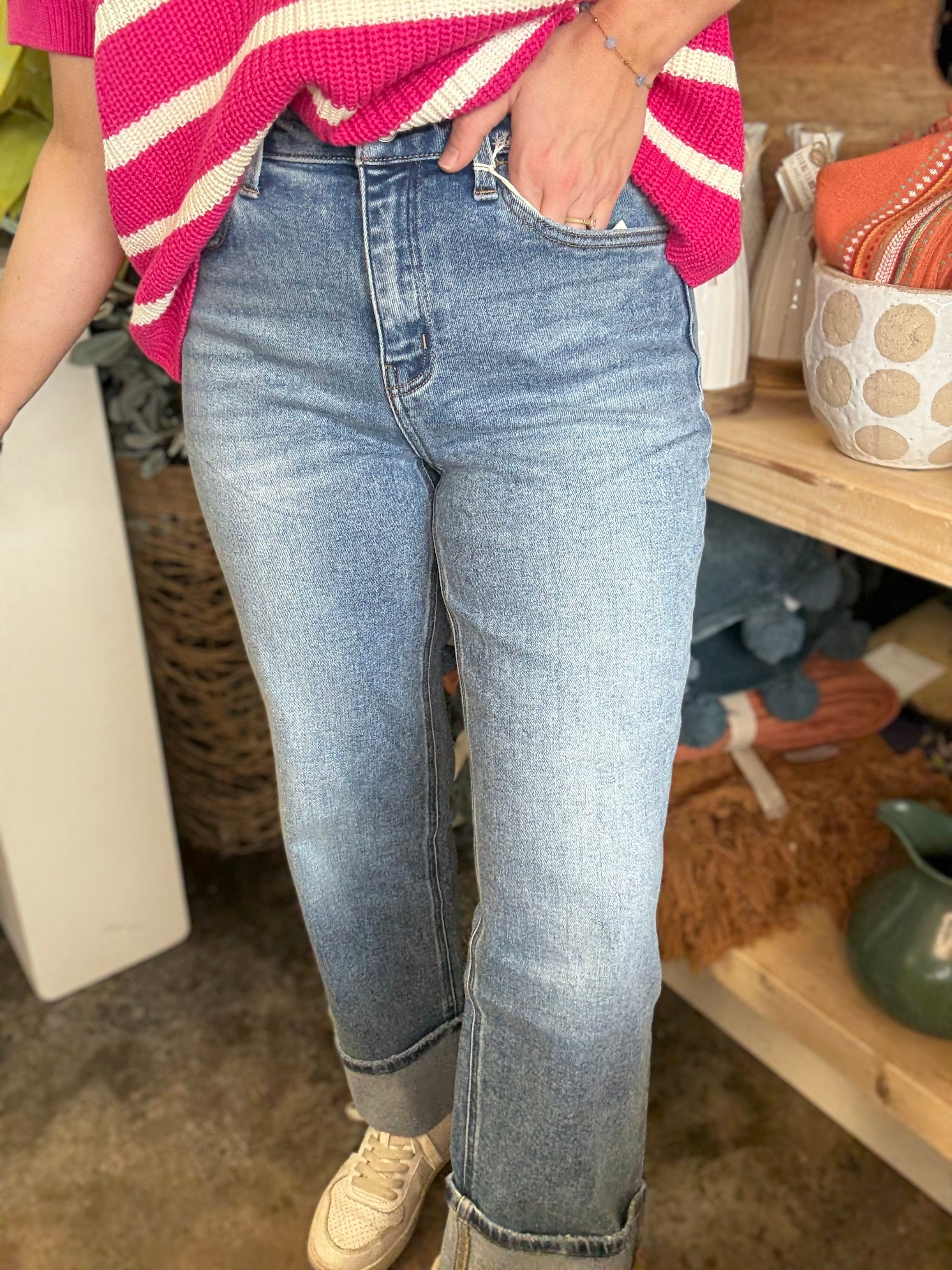 woman wearing mid rise straight leg cuffed boutique jeans