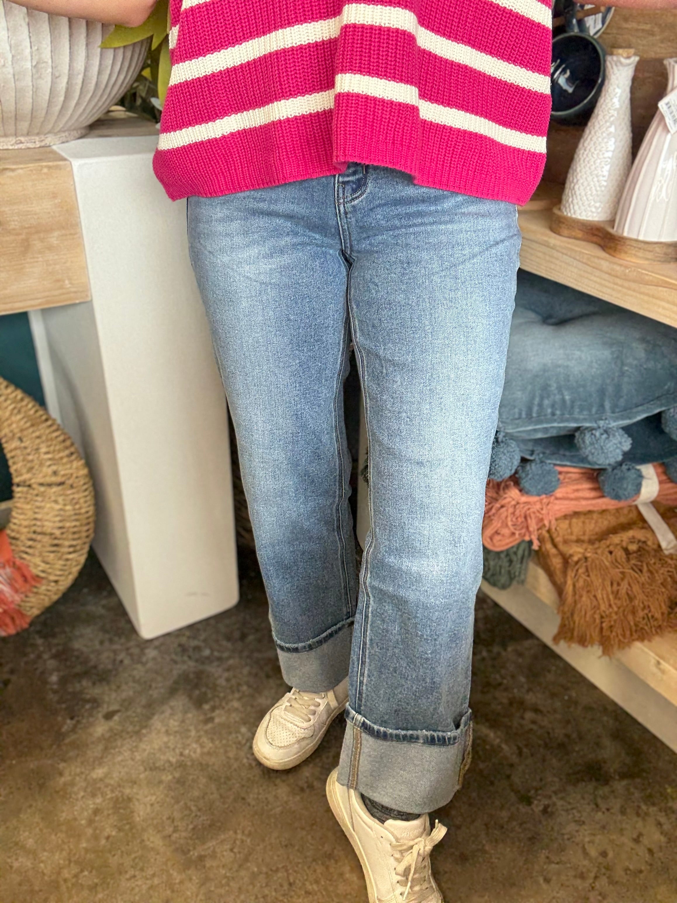 woman wearing mid rise straight leg cuffed boutique jeans