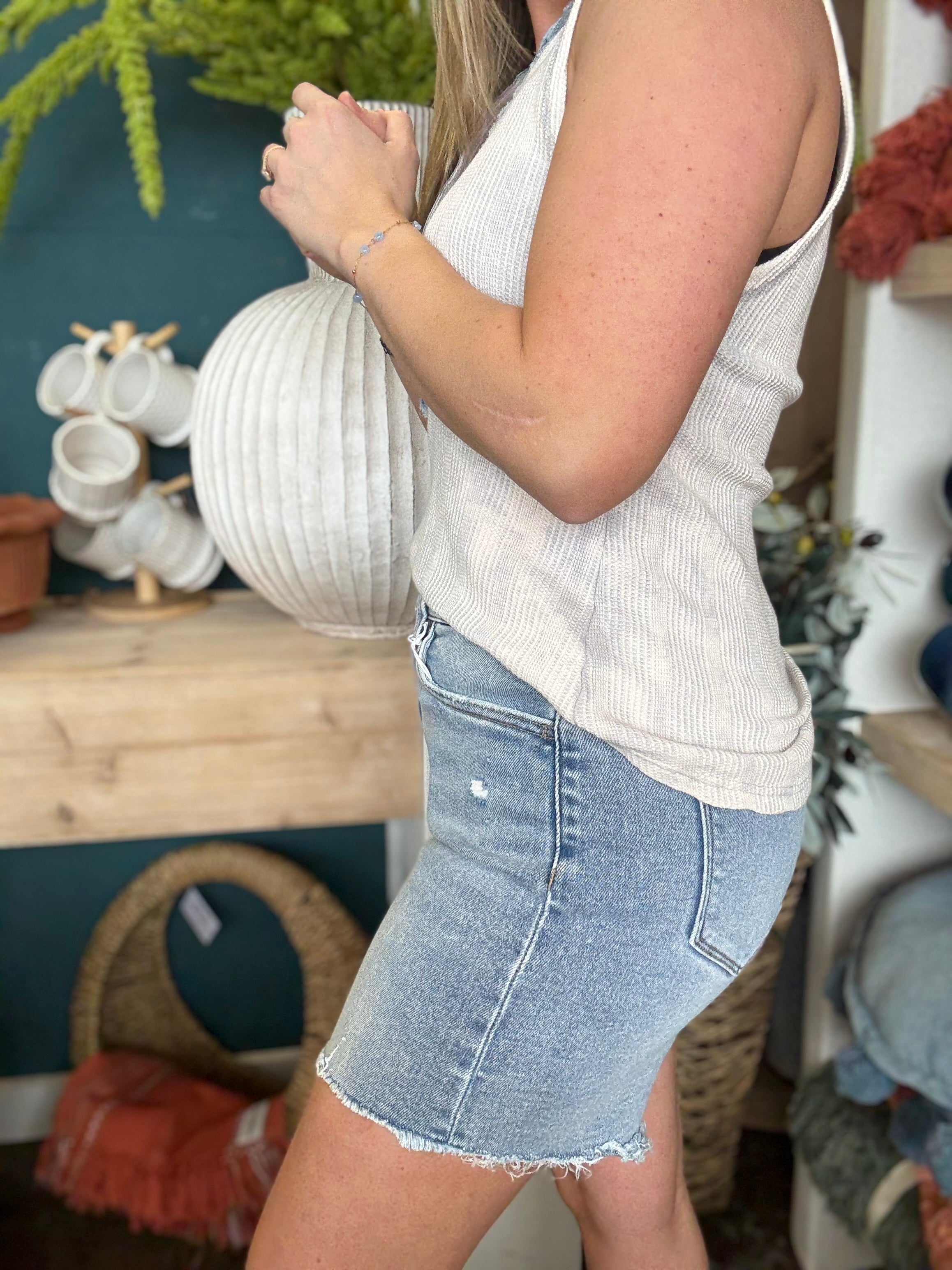 woman wearing vintage wash frayed hem denim boutique shorts