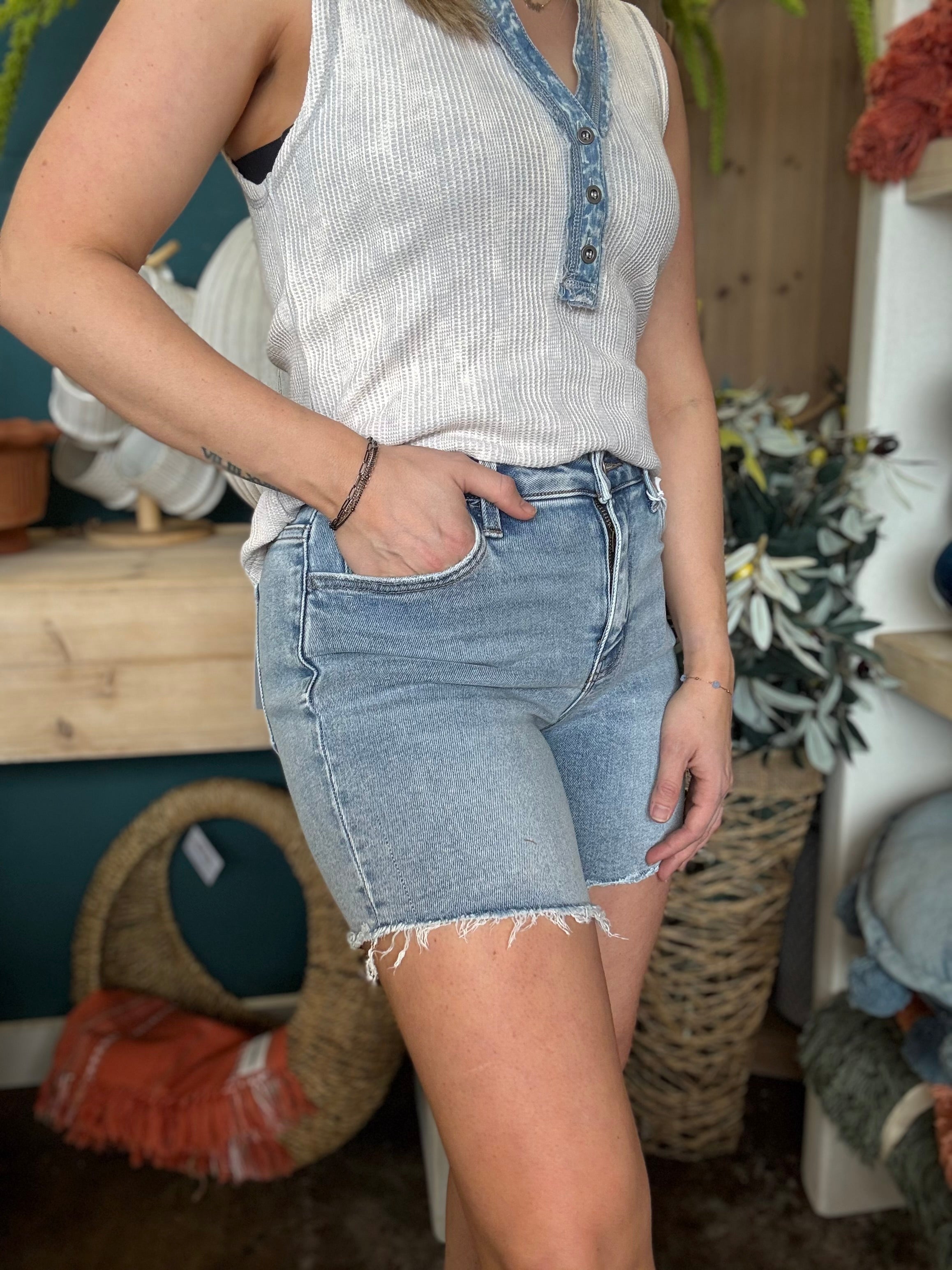 woman wearing vintage wash frayed hem denim boutique shorts