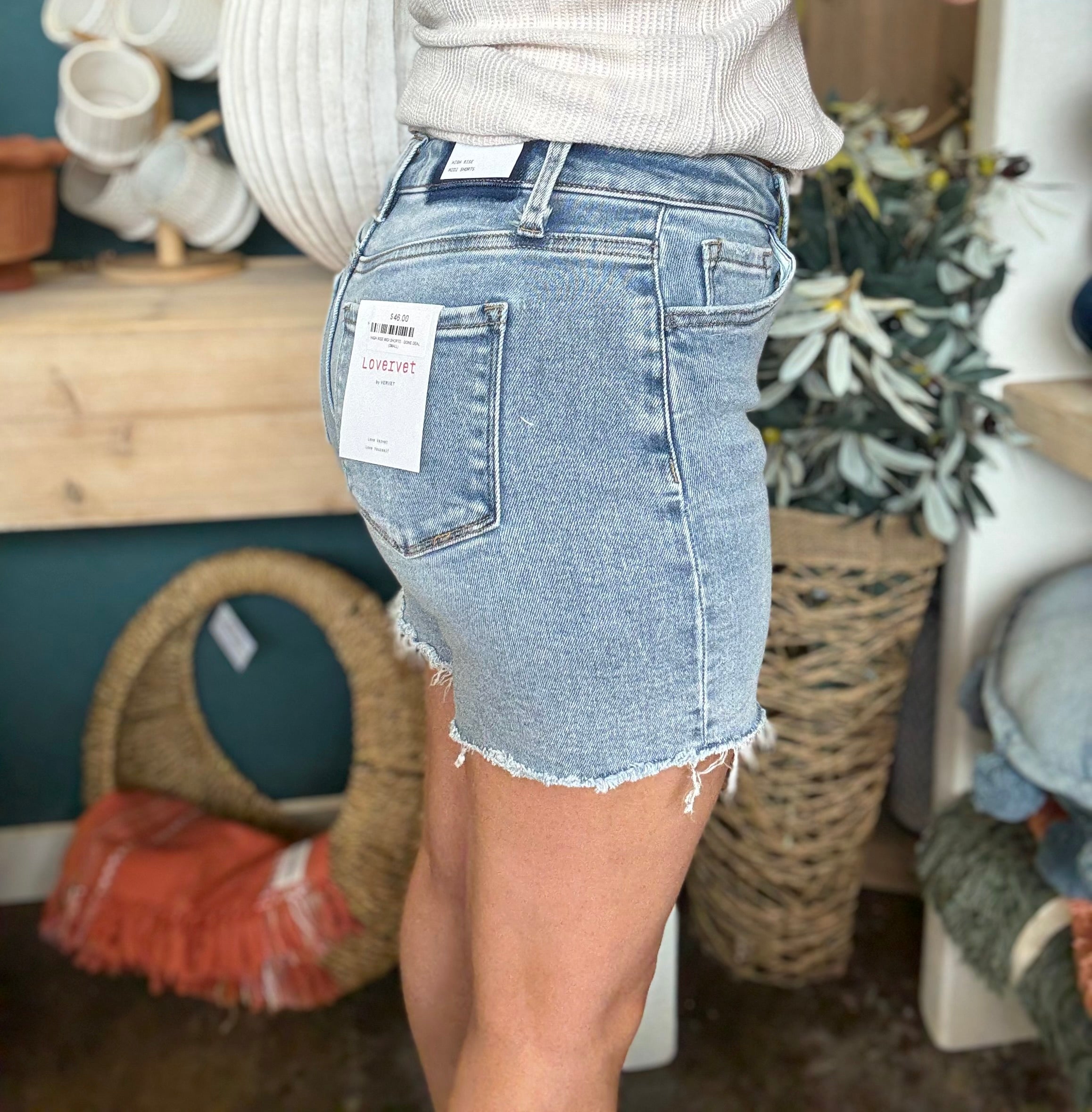 woman wearing vintage wash frayed hem denim boutique shorts