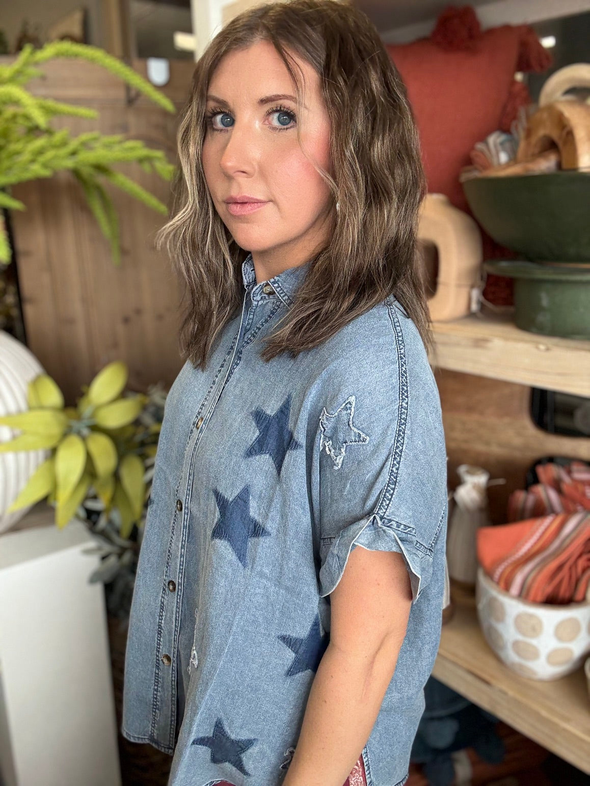 woman wearing vintage star wash denim oversized button-up boutique top