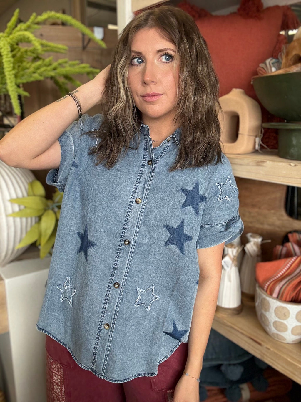woman wearing vintage star wash denim oversized button-up boutique top