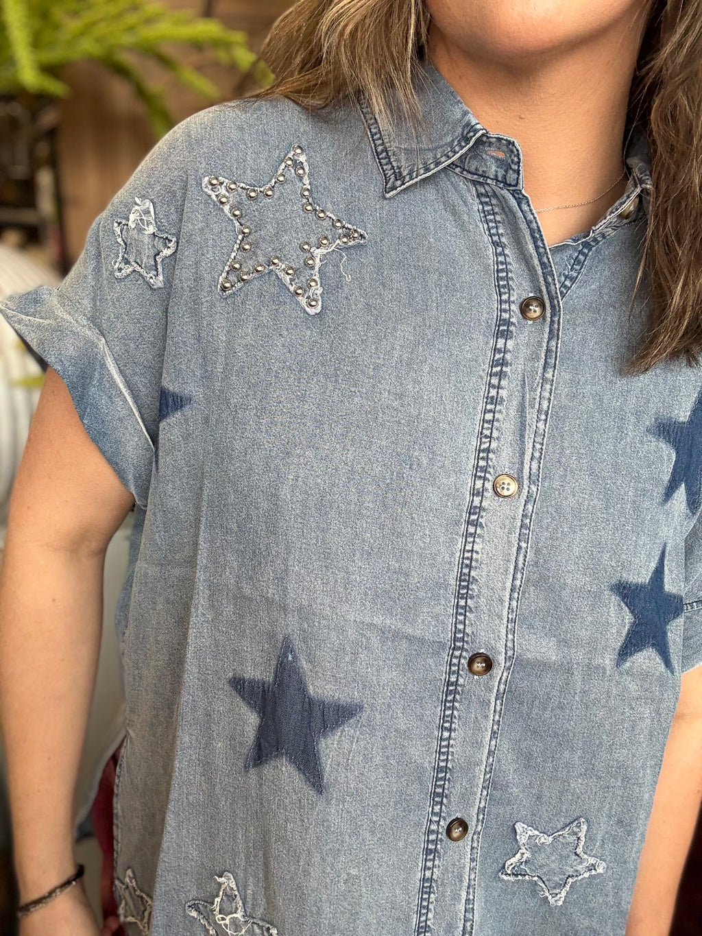 woman wearing vintage star wash denim oversized button-up boutique top