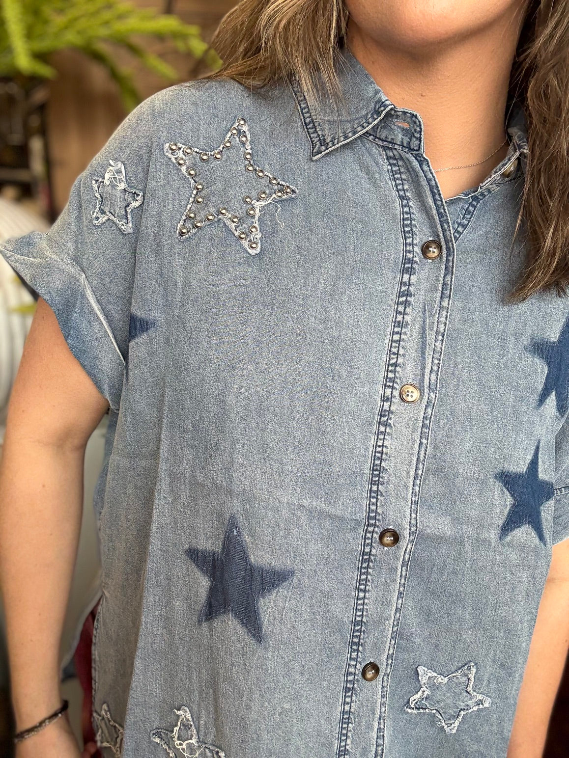 woman wearing vintage star wash denim oversized button-up boutique top
