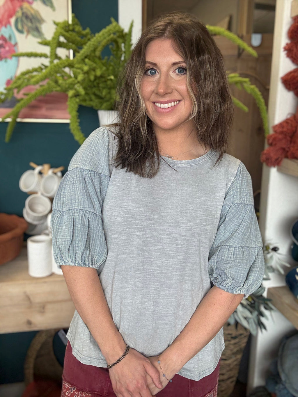 woman wearing heather grey puff sleeve boutique top
