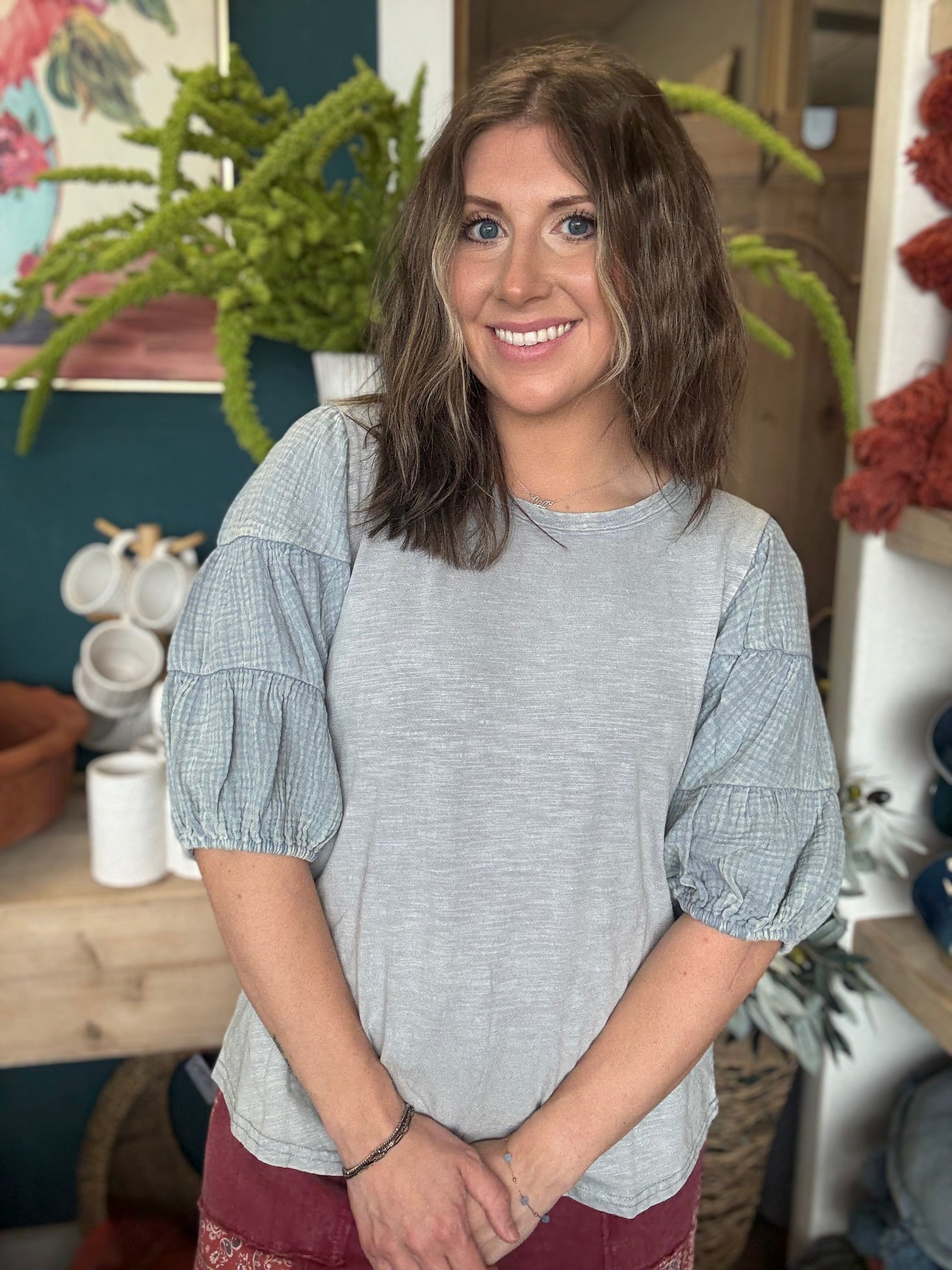 woman wearing heather grey puff sleeve boutique top