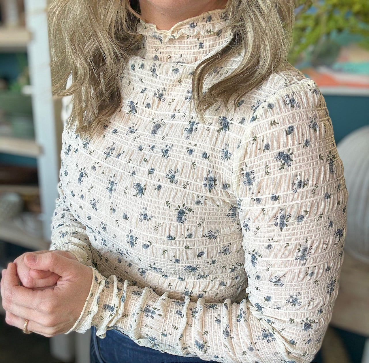 woman wearing floral smocked mock neck boutique top with long sleeves