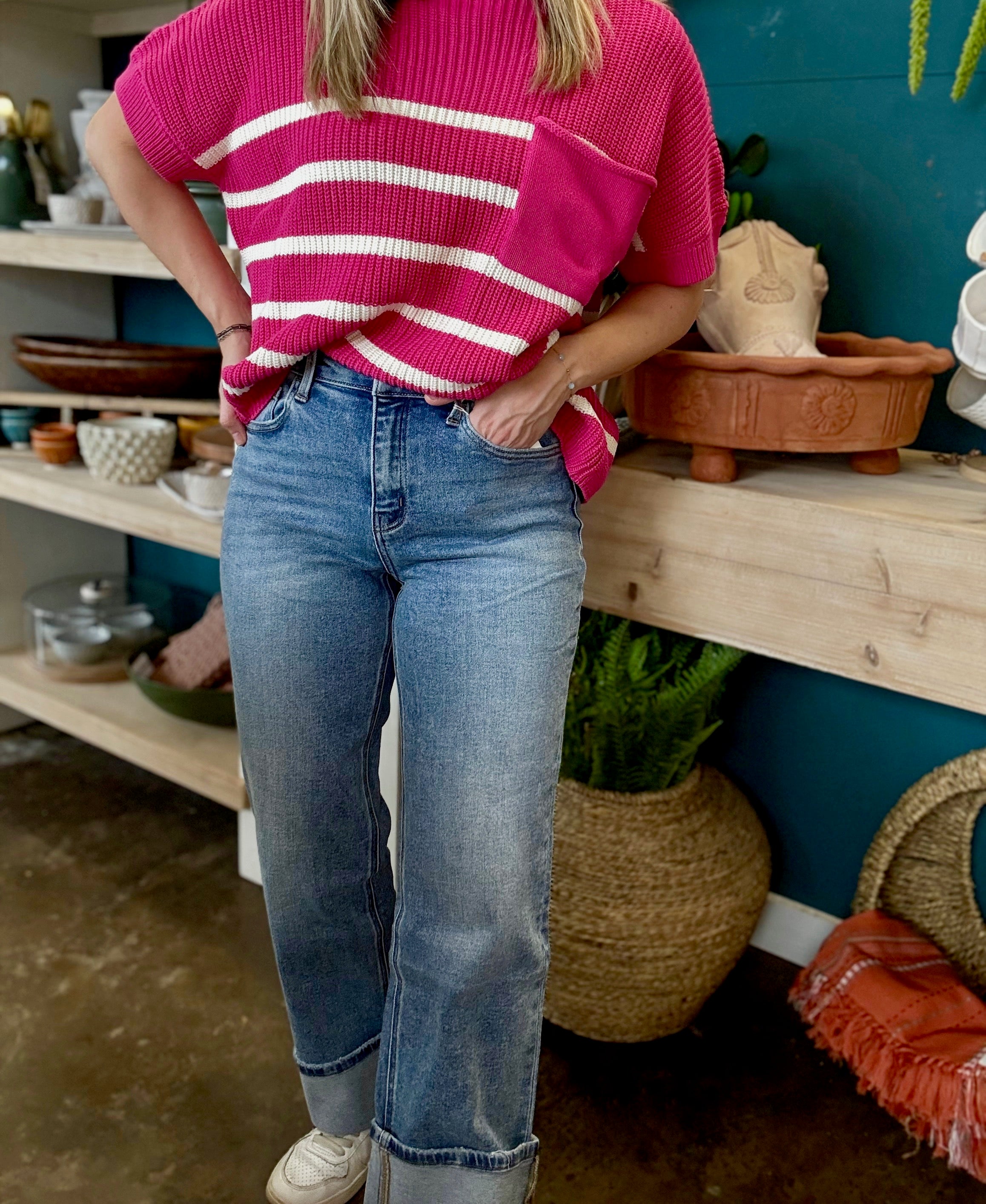 woman wearing mid rise straight leg cuffed boutique jeans